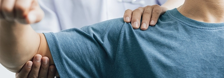 Chiropractic Torrance CA Arm Exam A patient in a blue shirt receiving an arm exam.