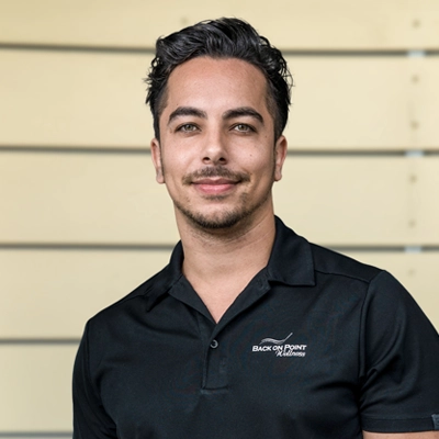 Chiropractic Torrance CA Giovanni Cardoso 1 Giovanni Cardoso smiling in a black shirt.