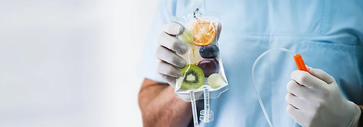 Chiropractic Torrance CA IV Therapy A person holding an IV bag. The bad is full of fruit.