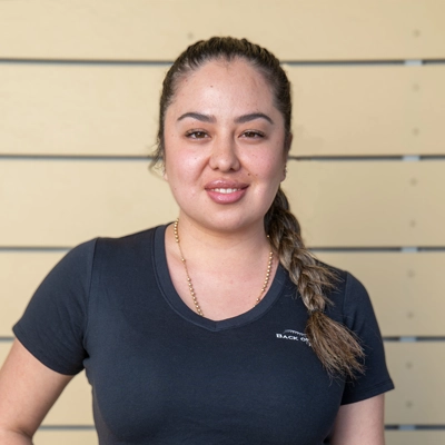 Chiropractic Torrance CA Karen Jaime 1 Karen Jaime smiling in a grey shirt.