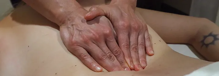 Chiropractic Torrance CA Manual Lymphatic Drainage A patient laying on their back with hands pressing into it.