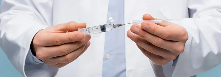 Chiropractic Torrance CA Peptide Therapy 1 A doctor holding a needle.