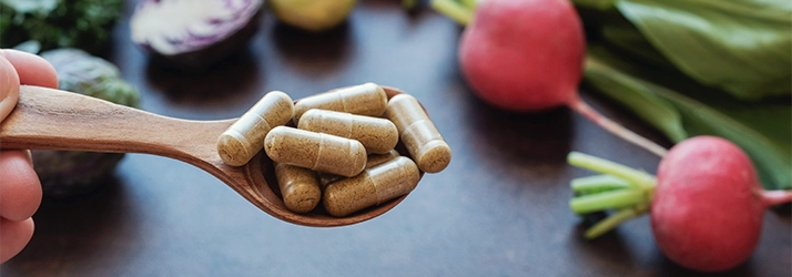 Chiropractic Torrance CA Supplements Pills on a spoon with radishes in that background.