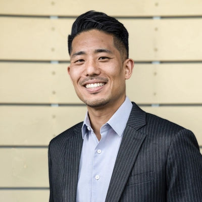 Chiropractor Torrance CA Ernest Kim 1 Ernest Kim smiling in a suit.