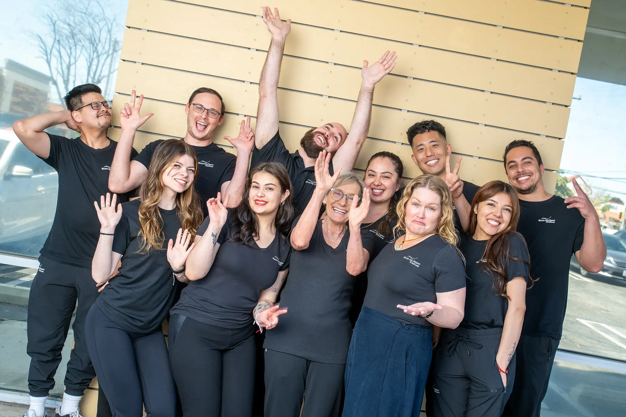 Chiropractors Ernest Kim, Reed Barnard, and Brian De Garmo acting goofy with staff.