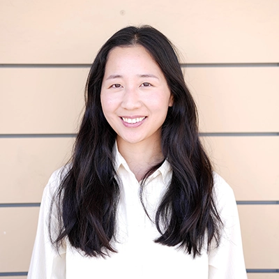 Naturopathic Doctor Dajin Shin In Front Of Wooden Wall