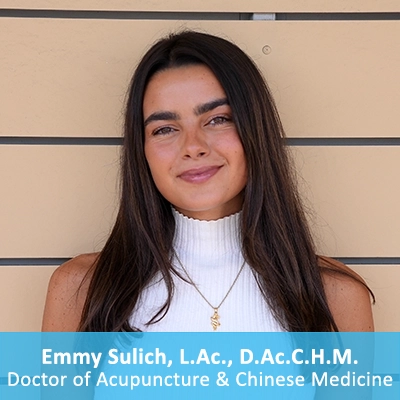 Doctor of Acupuncture & Chinese Medicine Emmy Sulich In Front Of Wooden Wall With Caption